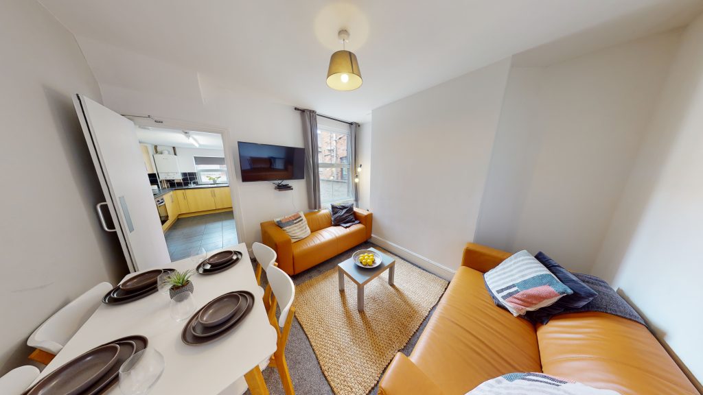 A cosy living room showcasing a dining space and lounge communal area for students